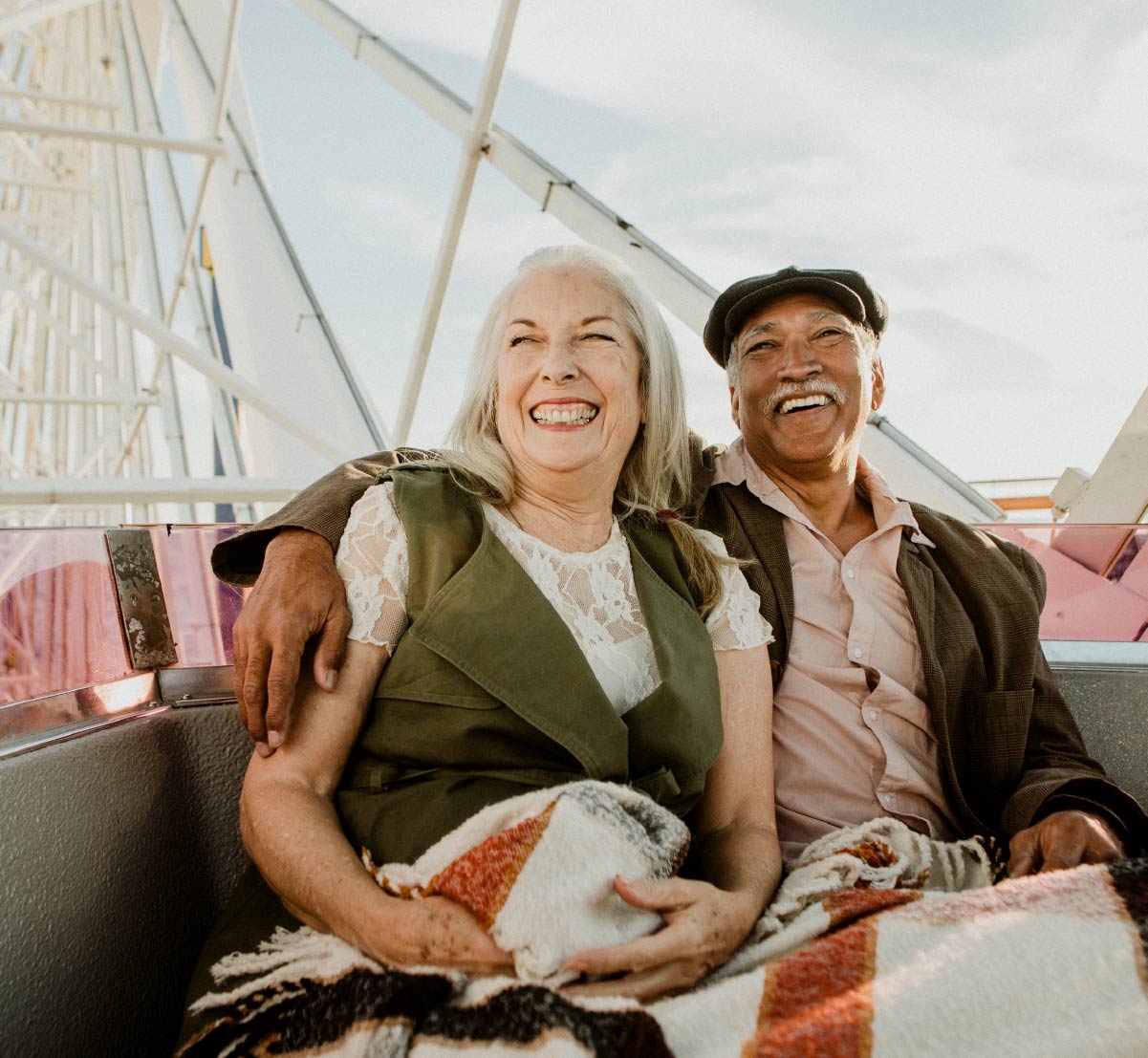 Retirement age man and woman riding a ferris wheel