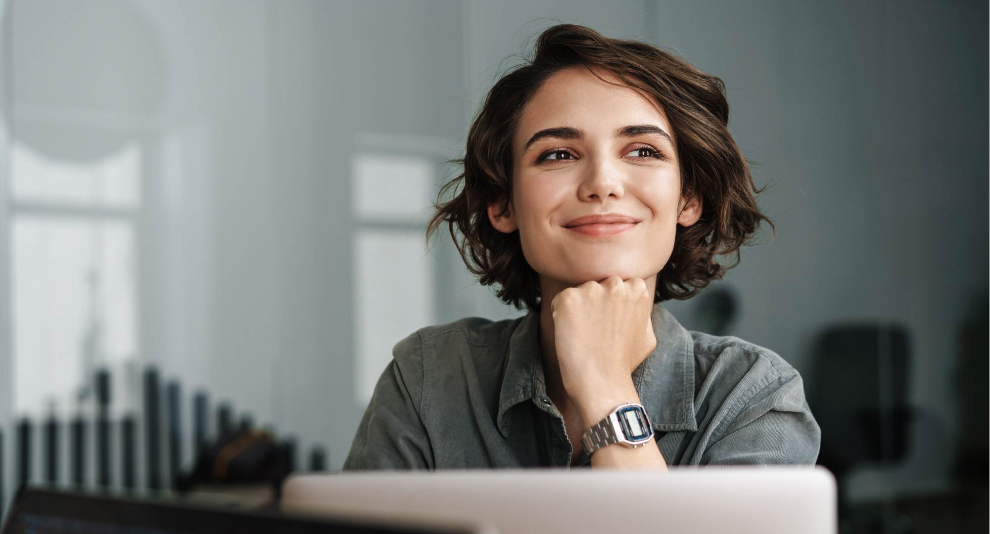 A professional woman sitting in an office, smiling